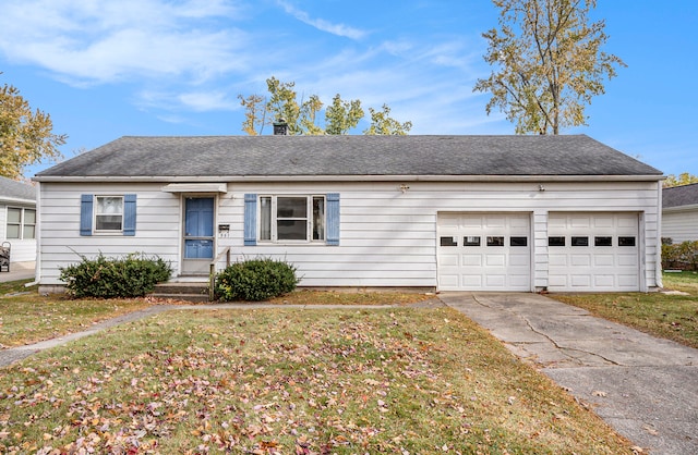 single story home featuring a garage and a front yard