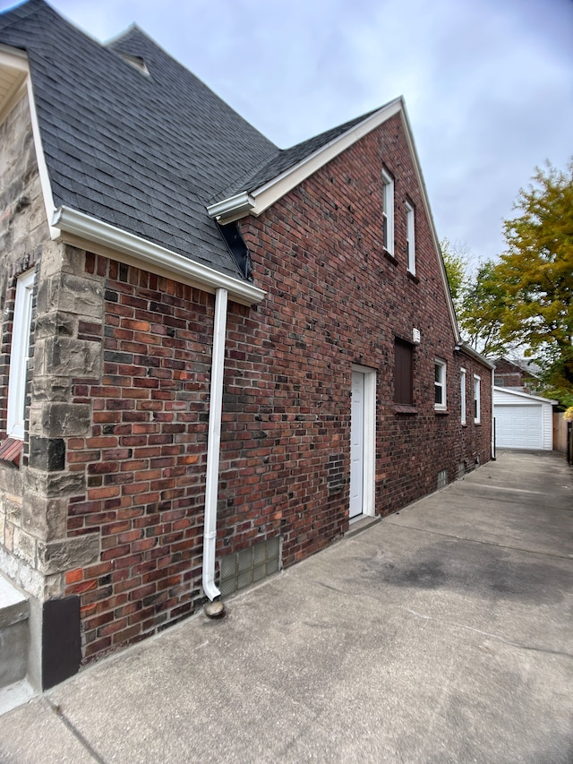 view of side of property with a garage and an outbuilding