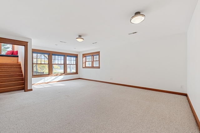 carpeted empty room with plenty of natural light