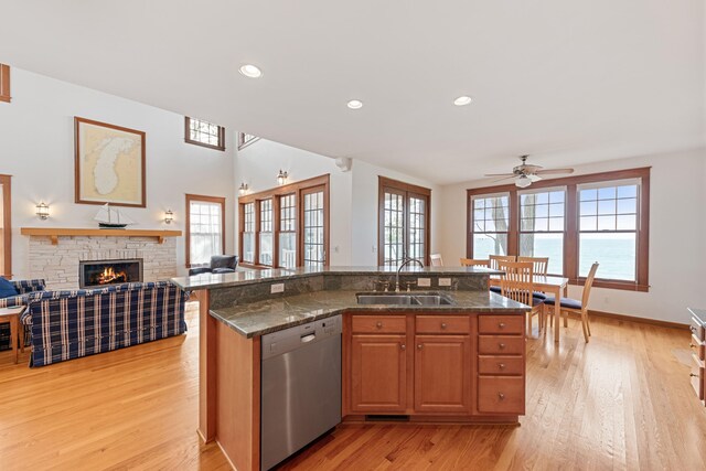 5722 Dunham Path, Stevensville, MI 49127 - kitchen featuring stainless steel dishwasher, a sink, open floor plan, ceiling fan, and light wood finished floors
