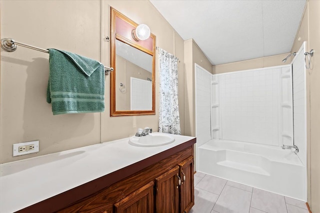 bathroom featuring a textured ceiling, vanity, tile patterned floors, and shower / bath combo with shower curtain