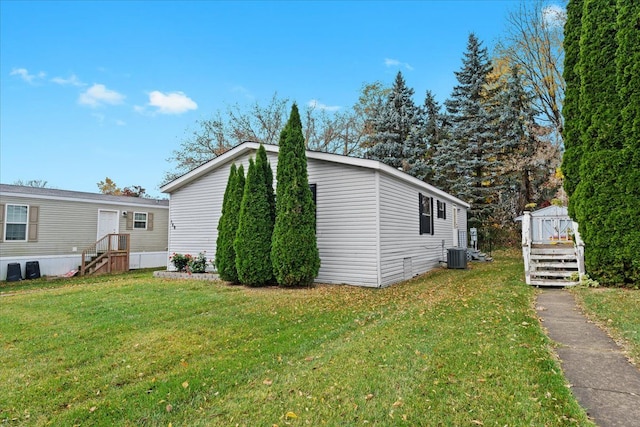 view of property exterior featuring central AC, a shed, and a lawn