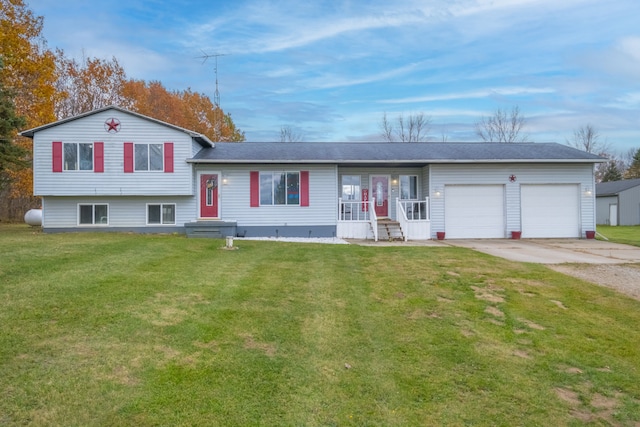 tri-level home featuring a garage and a front lawn