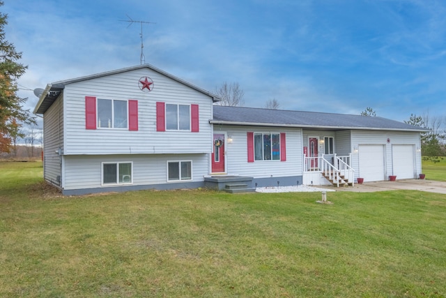 tri-level home featuring a front yard and a garage