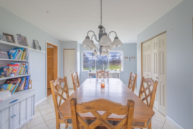 dining room featuring light tile patterned floors and a chandelier