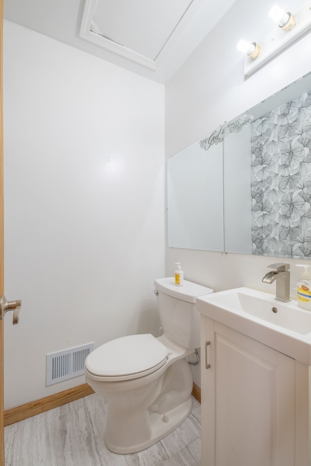 bathroom with hardwood / wood-style flooring, vanity, and toilet