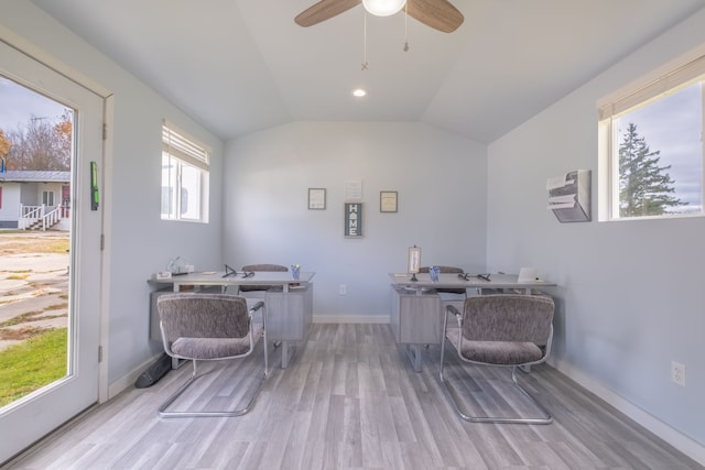 office space with plenty of natural light, light hardwood / wood-style floors, lofted ceiling, and ceiling fan