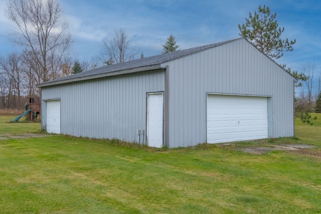 garage featuring a lawn