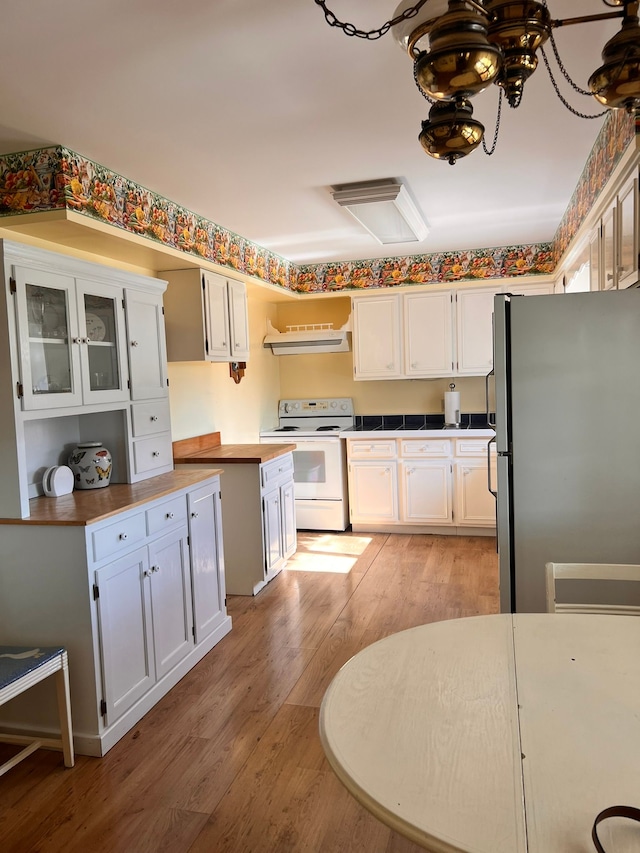 kitchen with stainless steel refrigerator, light hardwood / wood-style flooring, range hood, white electric stove, and white cabinets