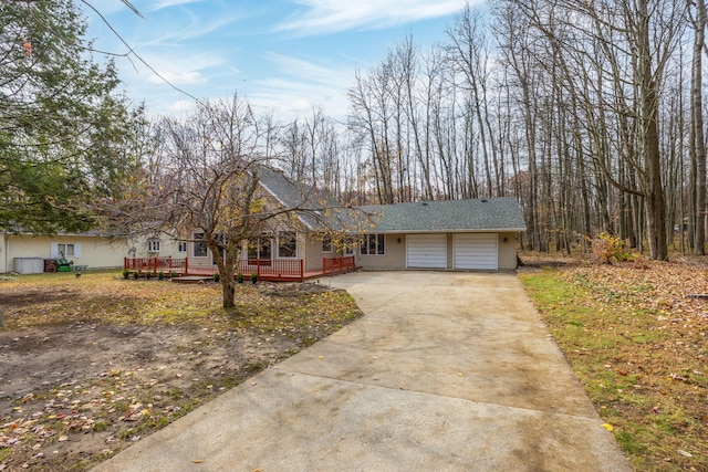 single story home featuring a garage and a deck