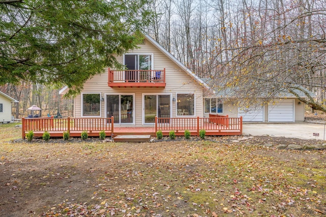 view of front of property featuring a balcony and a garage