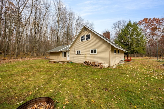 view of property exterior with a yard