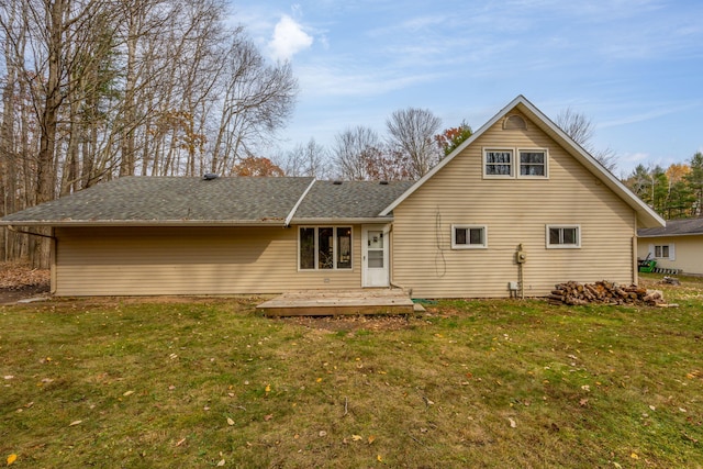 rear view of property featuring a lawn and a wooden deck