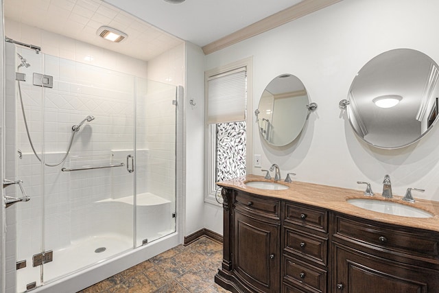 bathroom featuring vanity, a shower with shower door, and ornamental molding