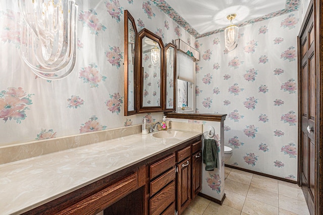 bathroom featuring tile patterned floors, vanity, and toilet