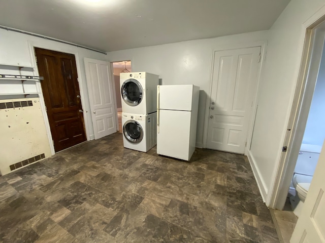 laundry room featuring stacked washer and dryer