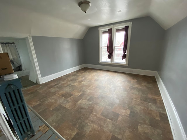 additional living space featuring lofted ceiling