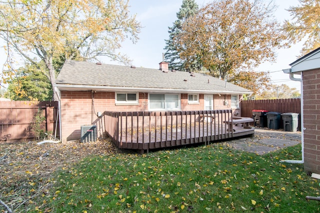 back of house with a lawn, cooling unit, and a wooden deck