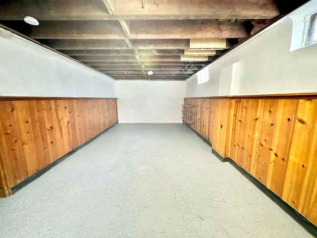 basement featuring wood walls