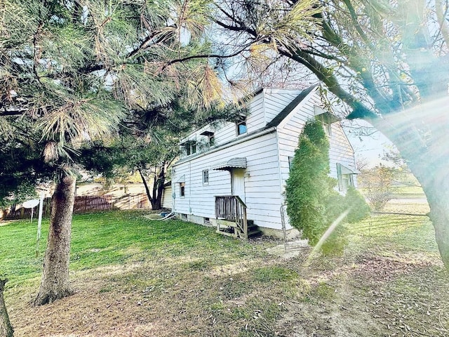 view of side of home featuring a yard