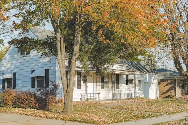 view of front of house featuring a porch and a garage