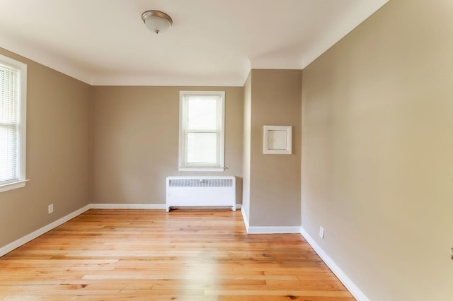 interior space featuring light hardwood / wood-style floors and radiator heating unit