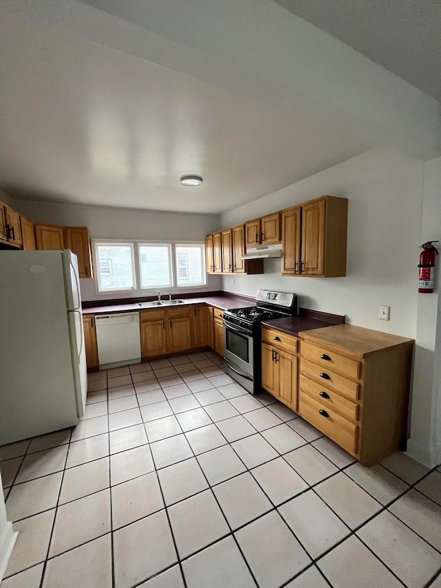 kitchen with light tile patterned floors, white appliances, and sink