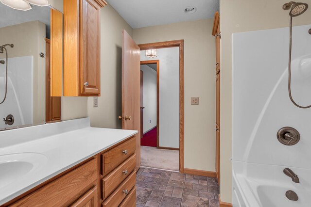 190 Steves Scenic Dr, Horton, MI 49246 - full bath with vanity, washtub / shower combination, stone finish floors, and baseboards