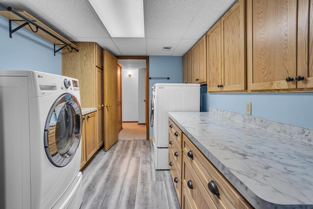 190 Steves Scenic Dr, Horton, MI 49246 - washroom featuring washer / dryer, cabinet space, and light wood-style flooring