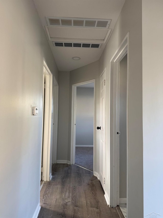 corridor with dark hardwood / wood-style flooring