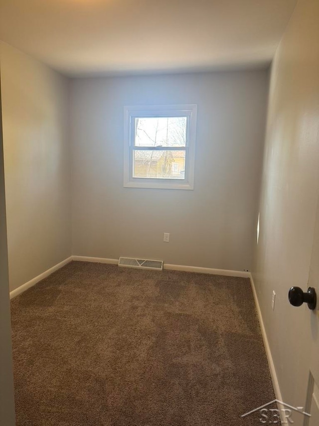 spare room featuring carpet