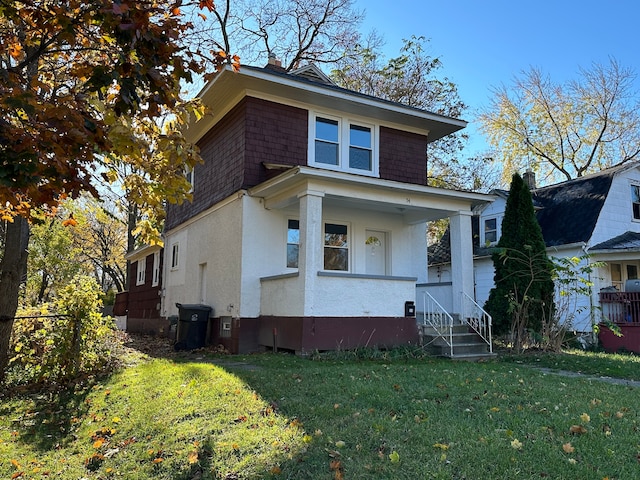 54 Nelson St, Pontiac, MI 48342 - american foursquare style home featuring a front yard and stucco siding