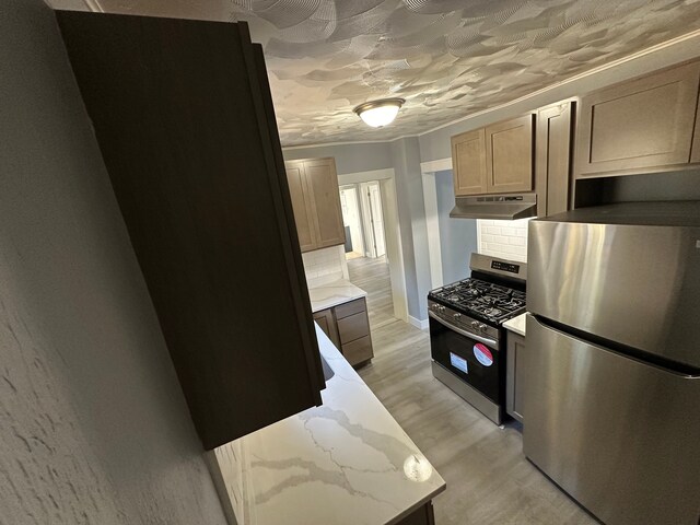 54 Nelson St, Pontiac, MI 48342 - kitchen with stainless steel appliances, under cabinet range hood, light wood-style floors, backsplash, and light stone countertops