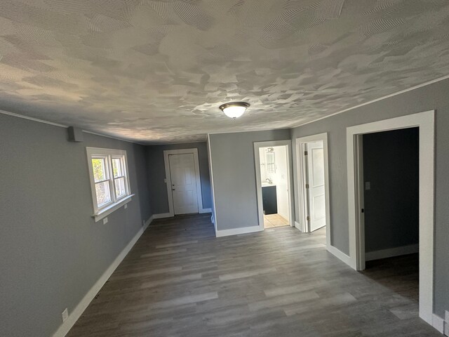 54 Nelson St, Pontiac, MI 48342 - empty room featuring baseboards, dark wood-type flooring, and a textured ceiling