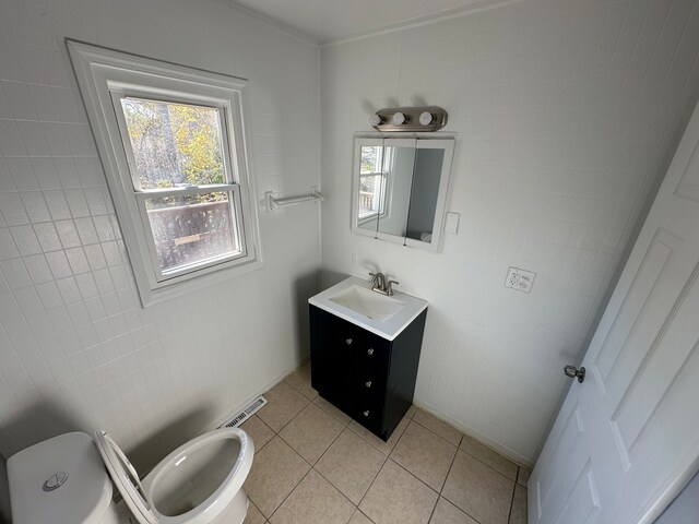 54 Nelson St, Pontiac, MI 48342 - half bath with toilet, vanity, tile patterned flooring, tile walls, and crown molding