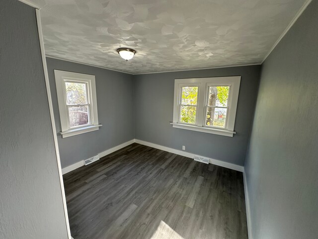 54 Nelson St, Pontiac, MI 48342 - spare room featuring plenty of natural light, baseboards, and dark wood-style floors