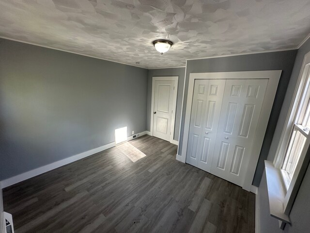 54 Nelson St, Pontiac, MI 48342 - unfurnished bedroom with dark wood-type flooring, baseboards, a closet, and crown molding