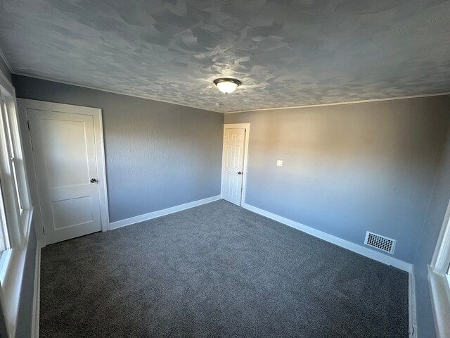 54 Nelson St, Pontiac, MI 48342 - unfurnished room featuring baseboards, dark colored carpet, and crown molding