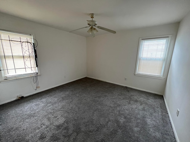 empty room featuring dark colored carpet and ceiling fan