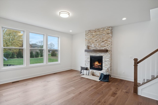 unfurnished living room featuring a fireplace and light wood-type flooring