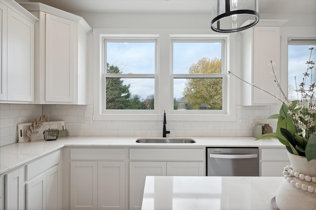 kitchen featuring white cabinetry, sink, backsplash, and dishwasher