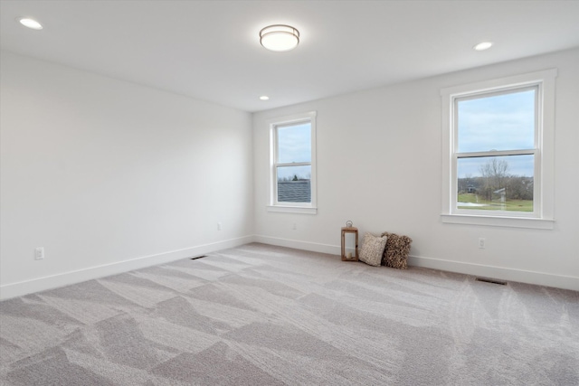 carpeted spare room with a wealth of natural light