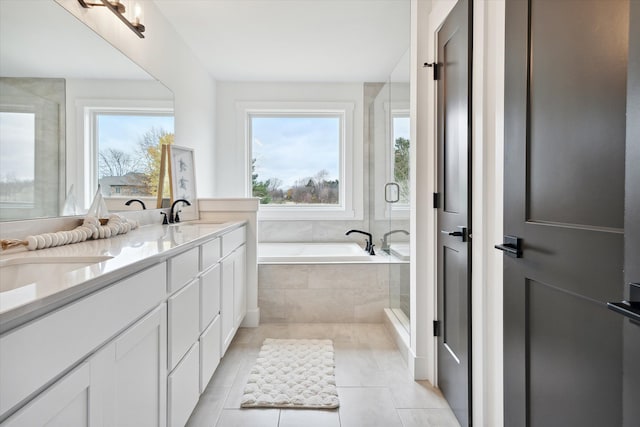 bathroom with vanity, tile patterned flooring, and shower with separate bathtub