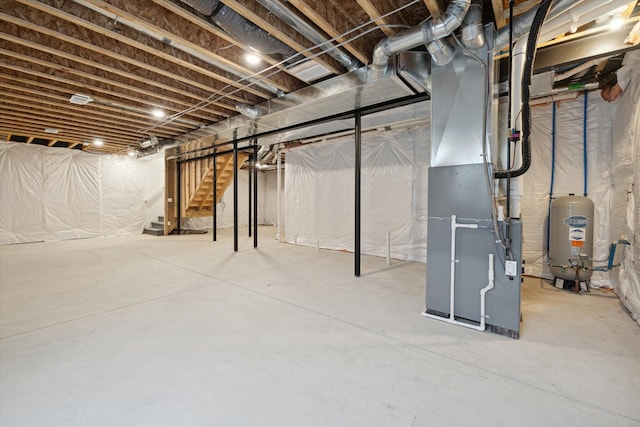 basement with water heater and heating unit