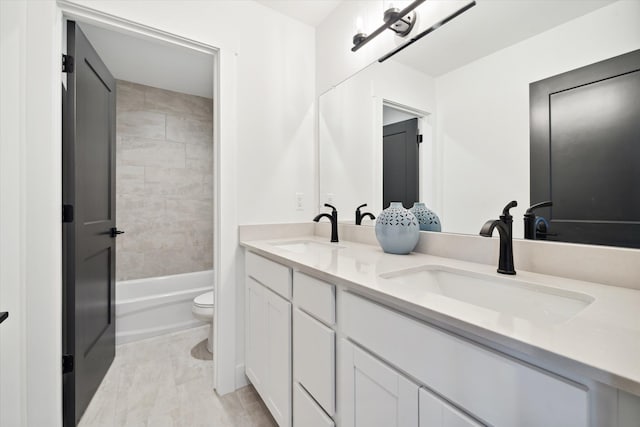 full bathroom with vanity, toilet, and tiled shower / bath combo