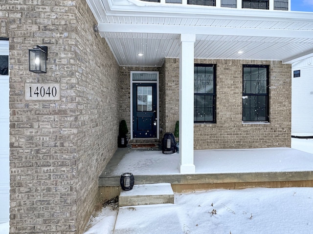 view of exterior entry featuring covered porch