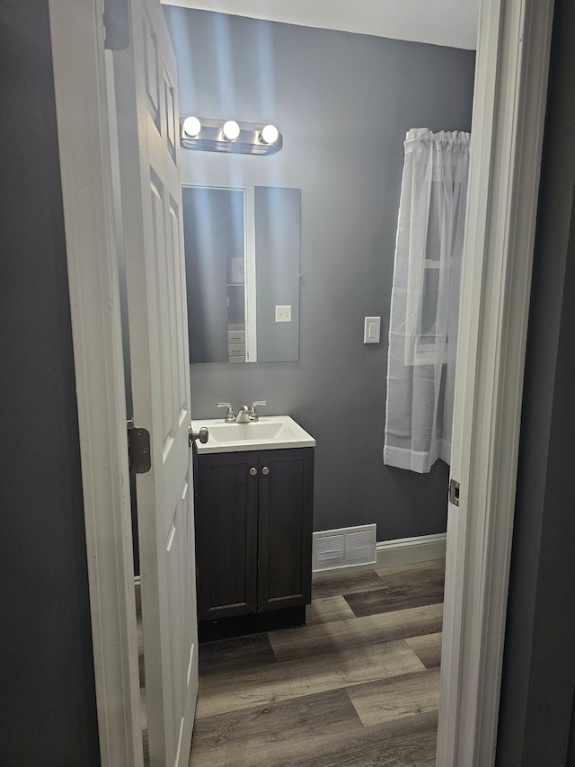 bathroom with vanity and hardwood / wood-style flooring