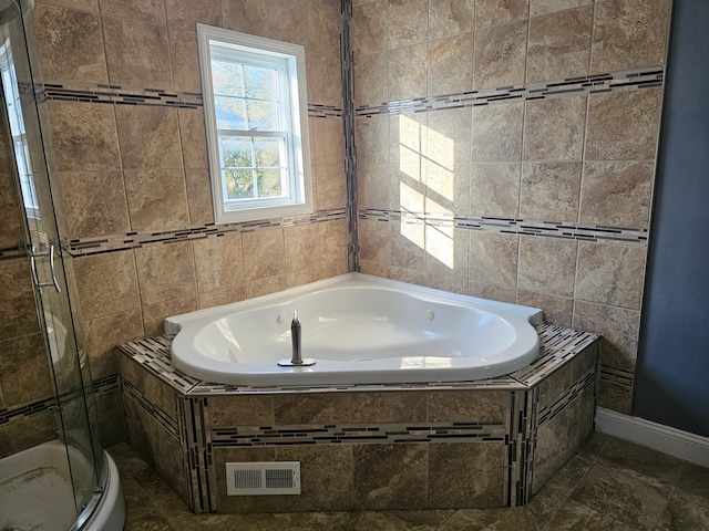 bathroom featuring separate shower and tub