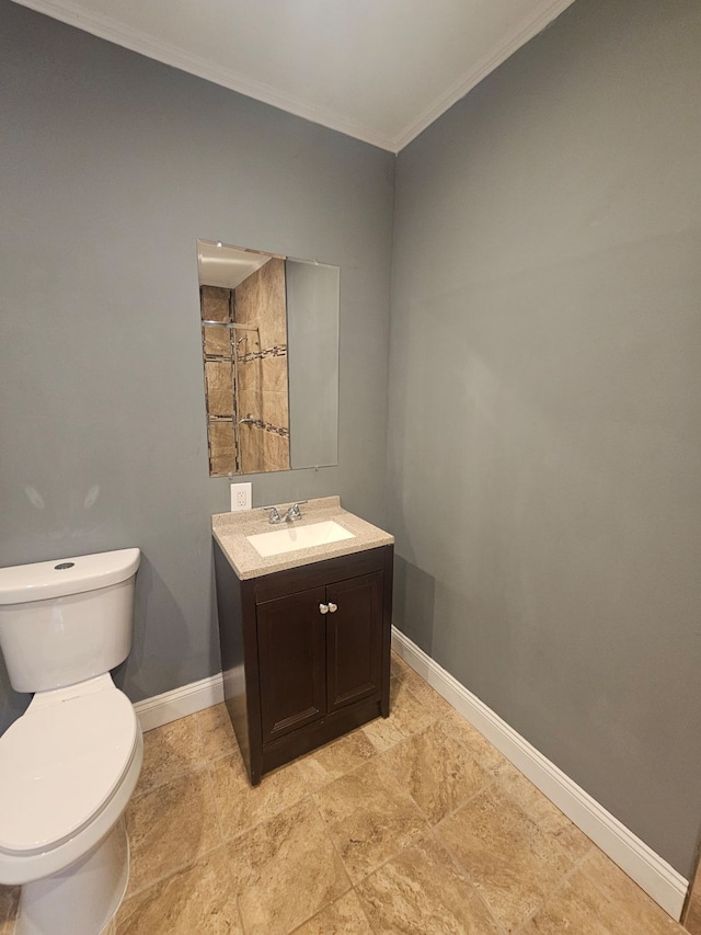 bathroom featuring crown molding, vanity, and toilet