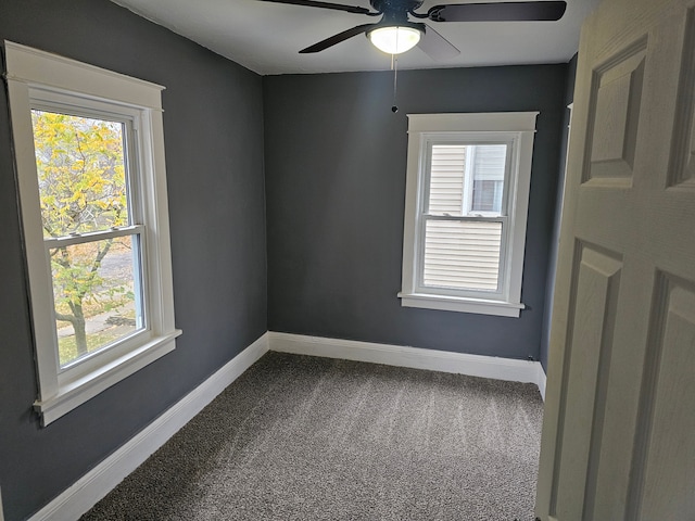 empty room with ceiling fan, a healthy amount of sunlight, and carpet